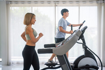 Fototapeta na wymiar Sporty people exercising in fitness gym