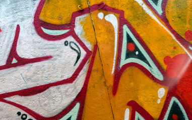 Colorful background of graffiti painting artwork with bright aerosol outlines on wall. Old school...