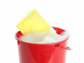 Plastic bucket with foam and sponge isolated on white. Cleaning supplies
