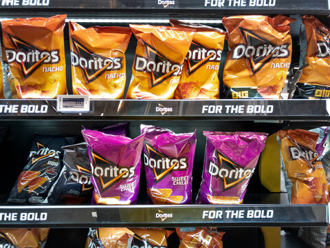 BELGRADE, SERBIA - JANUARY 12, 2023: Logo of doritos on bags for sale in a supermarket of Belgrade. Doritos is an american brand of tortilla chips sold worldwide, part of pepsico.