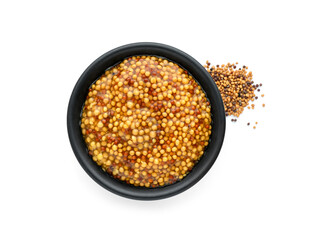 Fresh whole grain mustard in bowl and dry seeds isolated on white, top view