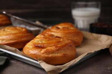 Delicious rolls on brown textured table, closeup. Sweet buns