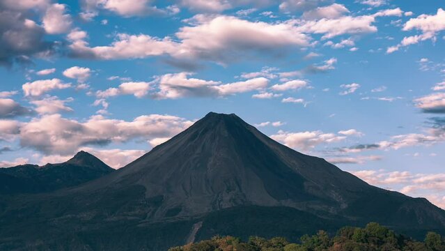 Breathtaking time-lapse over Colima's active volcano at sunset, sky turns from blue to fiery red