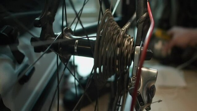 Close up: After adjusting shifters, bicycle chain spins rear sprocket