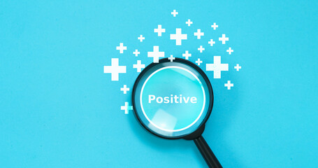 Concept Positive thinking by magnifying glass focus on positive with positive thinking sign on blue...