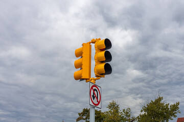 yellow traffic light with blue sky in the background
