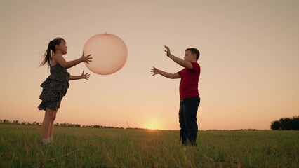 Girl Child Boy Kid playing big ball sunset, children dream flying, happy family, teamwork true happiness adventure, kid plays ball, boy, son, kick jump energy higher, group of people, relationships