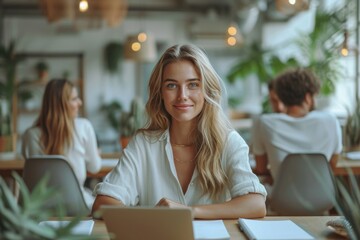 Smiling woman working on laptop in a modern office