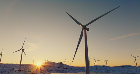 Renewable Energy Dawn: Wind Turbines Against a Wintry Sunrise