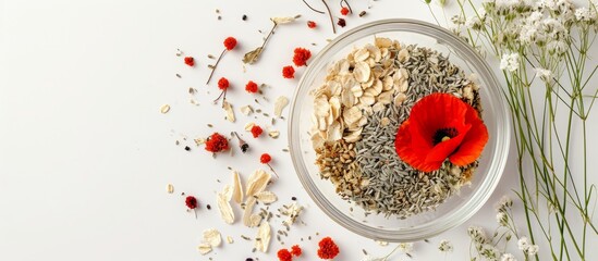 Dried cereals, poppy heads, and herbs in a glass bowl with red poppy and everlasting flowers on white background.