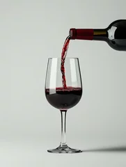 Fotobehang wine pours from a bottle into a glass © hakule