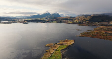 Aerial View of Scenic Lofoten Islands Along E10 Route with Distant Church and Majestic Mountains