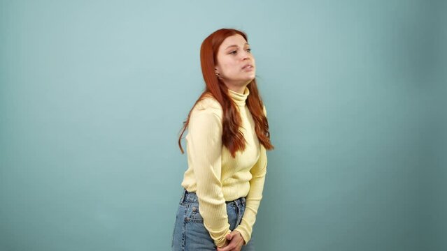 Caucasian woman in her 30s really need to pee and looking very worried in a studio
