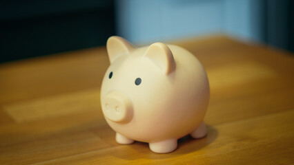 Piggy bank on a table with a soft-focus background, concept for savings and finance.