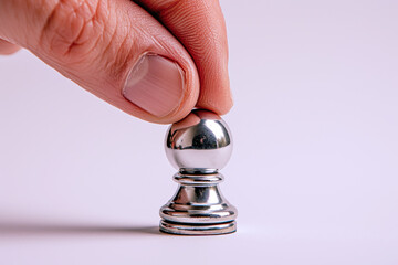 Hand holding silver chess pieces isolated on white, business strategy