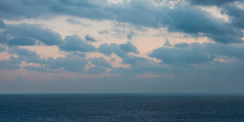 Seascape under a sky covered with dark clouds in the early morning