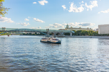 View of the Moscow river embakment, Pushkinsky bridge and cruise ships at sunset.