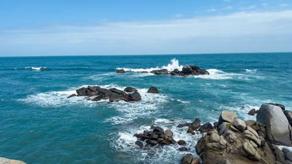 Muurstickers Waves crashing on rocks in Tayrona National Park © Lucas