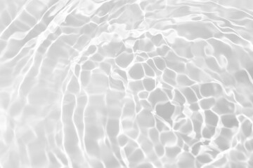 White water with ripples on the surface. Defocus blurred transparent white colored clear calm water surface texture with splashes and bubbles. Water waves with shining pattern texture background.