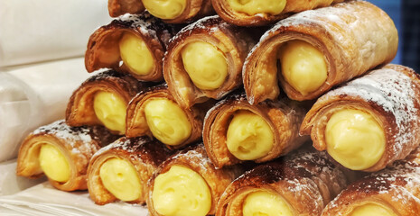 Pile of custard pastry rolls in patisserie