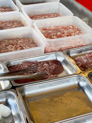 a variety of trays of food with meat and vegetables
