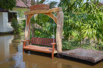 a wooden bench sitting in a flooded area