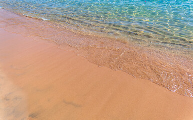 Soft wave of the sea on the sandy beach.