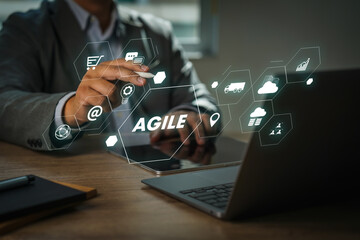 A businessman using a laptop computer Agile management and the principles of agile software development