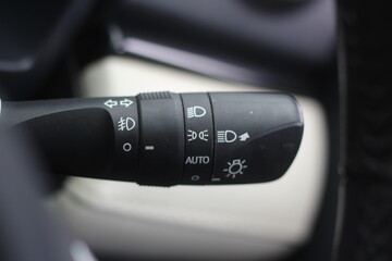The light knob in the car. Multifunction Headlight Console Control Switch knob. Car interior with...