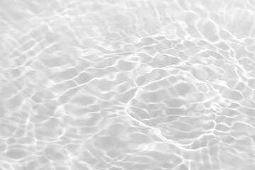 White water with ripples on the surface. Defocus blurred transparent white colored clear calm water surface texture with splashes and bubbles. Water waves with shining pattern texture background.