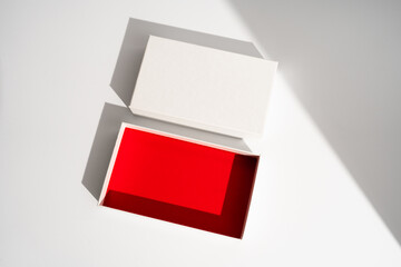 White square gift box mockup on white background, harsh shadows, red inside. From above, top view, minimalist concept, mock up, luxury - 730592016