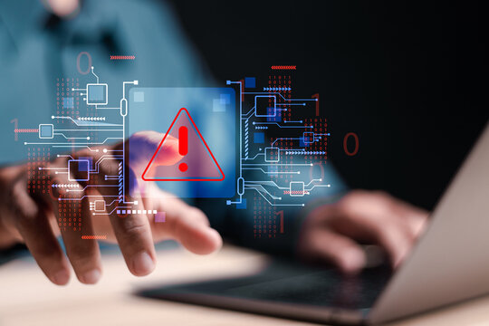 System hacked warning alert. Person use laptop with virtual warning sign for cyber attack. Ransomware, Virus, Spyware, Malware or Malicious software, Data breach, Cyber security and cybercrime.