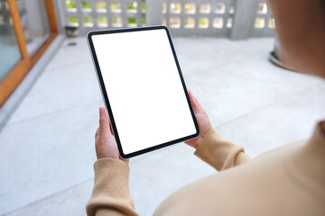 Mockup image of a woman holding digital tablet with blank white desktop screen