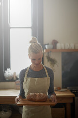 Bakery, kitchen and woman with bread on tray for cooking with healthy gluten free food for...