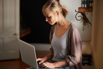 Woman, freelancer and laptop for networking, remote work and internet connection in kitchen for...