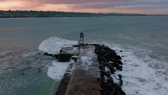 Aerial: Breakwater and beacon in Oamaru, Otago, New Zealand.
