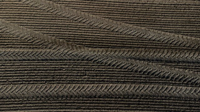 Tractor tyre tracks form an interesting pattern on a freshly cultivated field without vegetation, drone image, Upper Bavaria, Bavaria, Germany, Europe