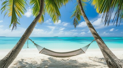 hammock strung between two palm trees on a white sandy beach, turquoise ocean in the background. 