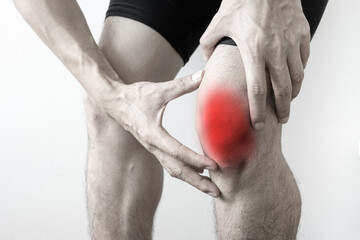 Man with knee pain, he puts his hand on his knee, pain point from osteoarthritis and...