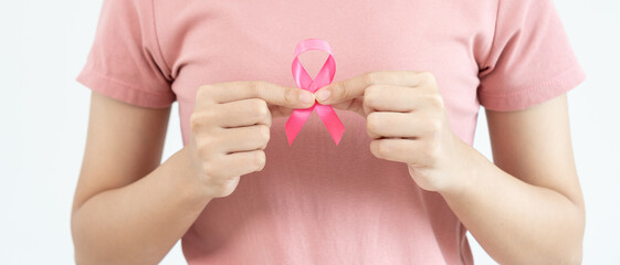 Woman hold pink ribbon breast cancer awareness. Female health check consciousness. international Women Day and World Cancer Day. sign cancer, Symbolic, health care, support patients, timely diagnosis