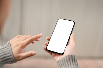 A close-up image of a white-screen smartphone mockup in a woman's hand with a blurred background.