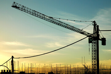 Large industrial crane structure at a construction site. Silhouetted in orange sunset. Australia. No people.
