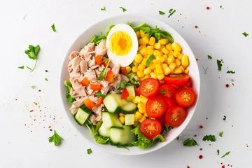 Poster tuna salad with egg, vegetables and corn in bowl spices, top view © -=RRZMRR=-
