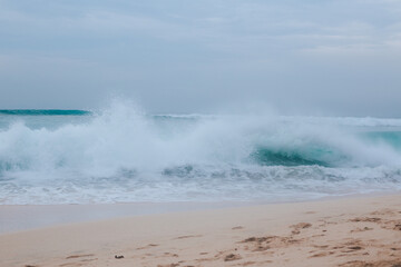 Big blue wave and spray view from the shore