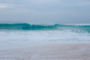 Beautiful turquoise wave near the shore.