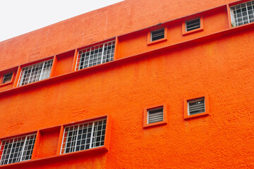 Bright red wall and windows. Concrete building façade