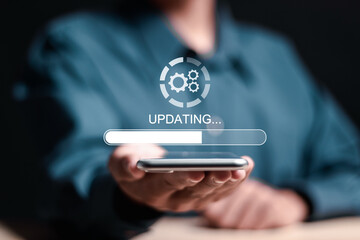 Software update or operating system upgrade. Person use smartphone with virtual installing update bar. Improved functionality in the new version and improved security.
