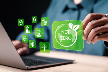 Net zero and carbon neutral concept. Businessman use laptop with virtual net zero icon for net zero...