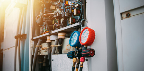 Technician is checking air conditioner refrigerant leak.
