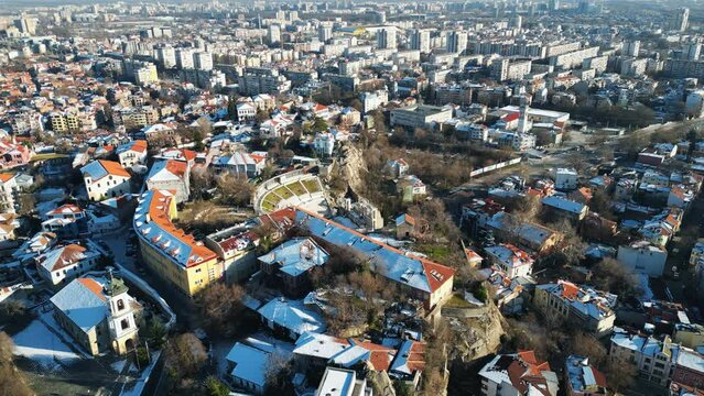 Aerial drone view of the ancient Theatre of Philippopolis. Orange roofs covered in snow. The city center of Plovdiv, Bulgaria